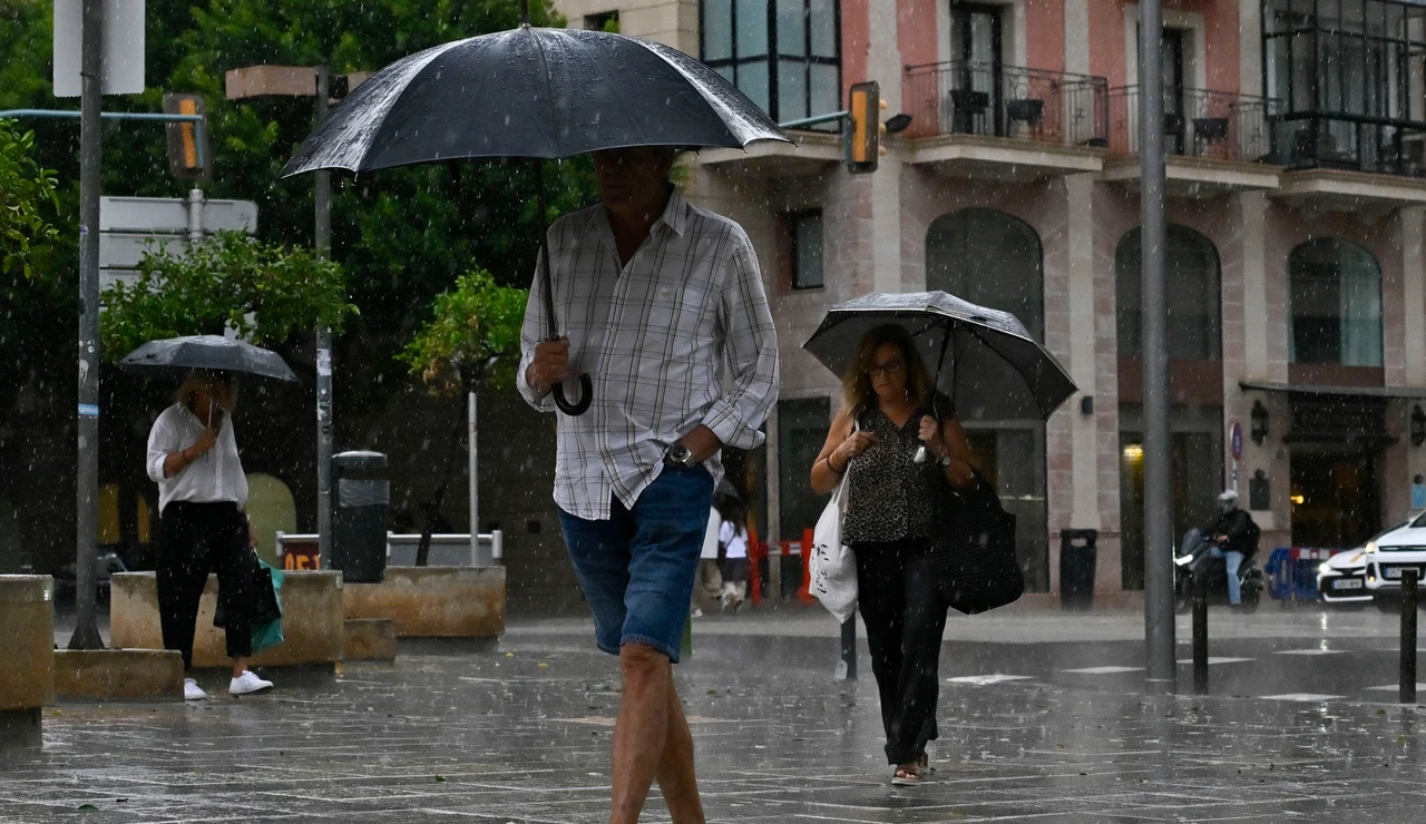 Personas protegiéndose de la lluvia