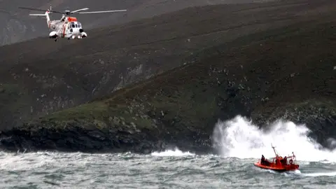 El helicóptero y la barcaza de Salvamento marítimo El helicóptero y la barcaza de Salvamento marítimo