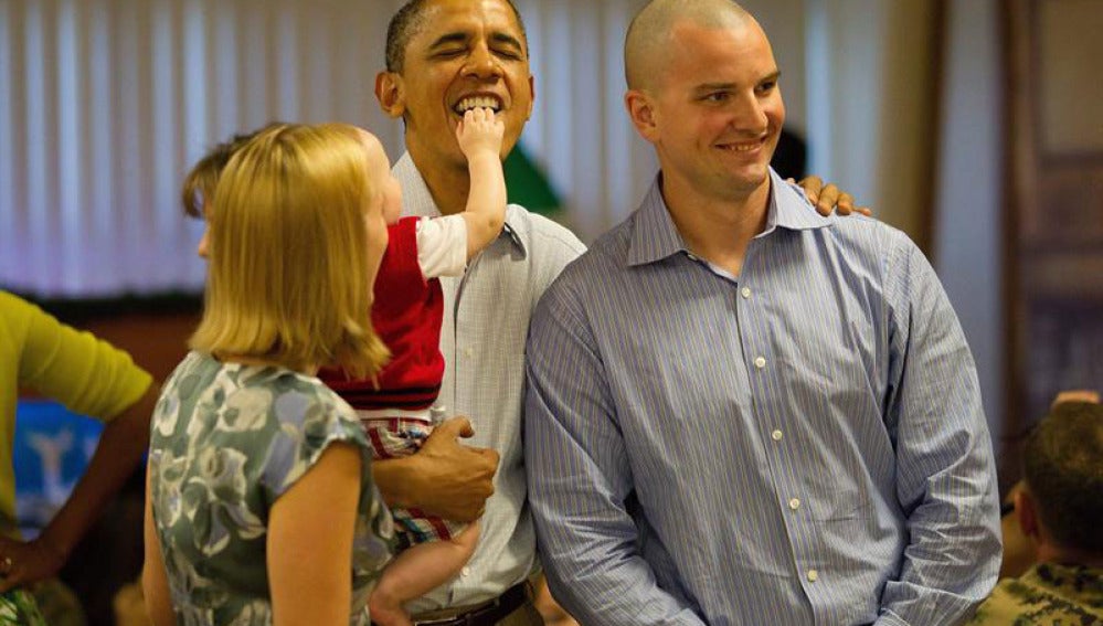 Un bebé mete la mano en la boca de Obama