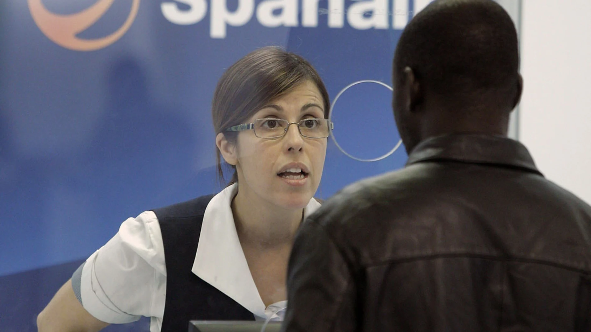 Una empleada de Spanair atiende en uno de los mostradores Una empleada de Spanair atiende en uno de los mostradores