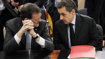 El primer ministro español, Mariano Rajoy (i), charla con el presidente francés, Nicolas Sarkozy