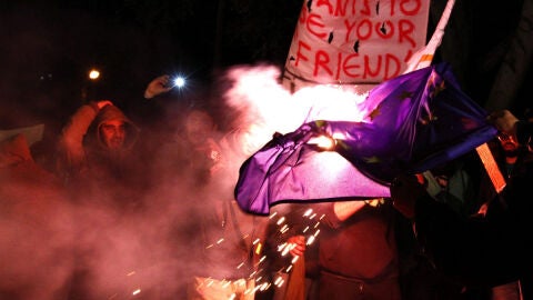 Queman una bandera de la UE frente al Parlamento