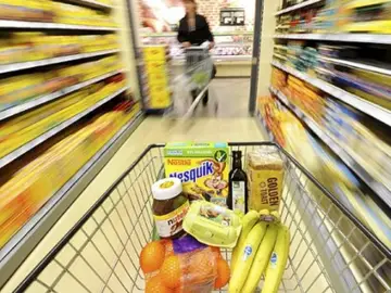 Un carrito de la compra en un pasillo de un supermercado Un carrito de la compra en un pasillo de un supermercado