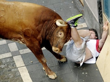 Un corredor embestido varias veces por un toro