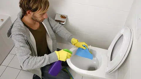Hombre limpiando wc Hombre limpiando wc