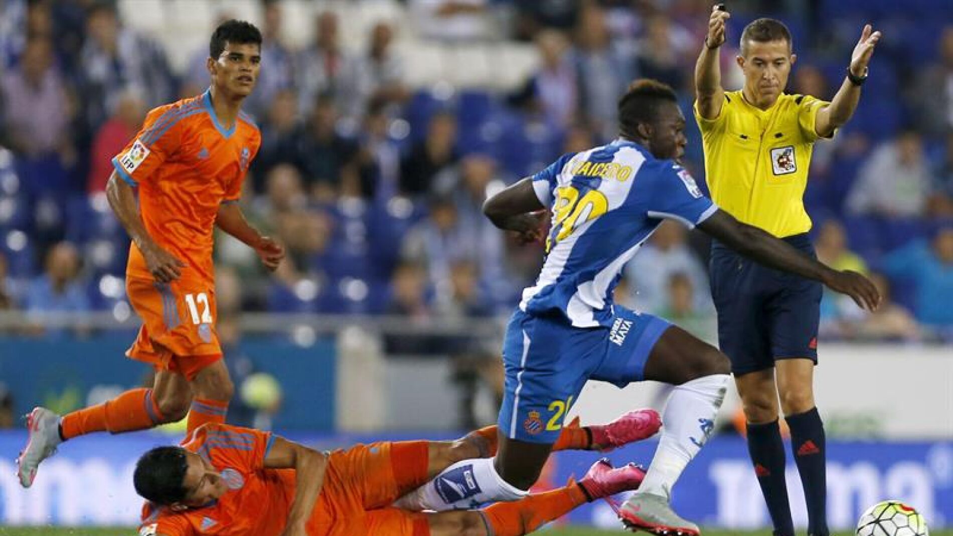 Caicedo se lleva el bal&oacute;n ante la presi&oacute;n de los jugadores del Valencia