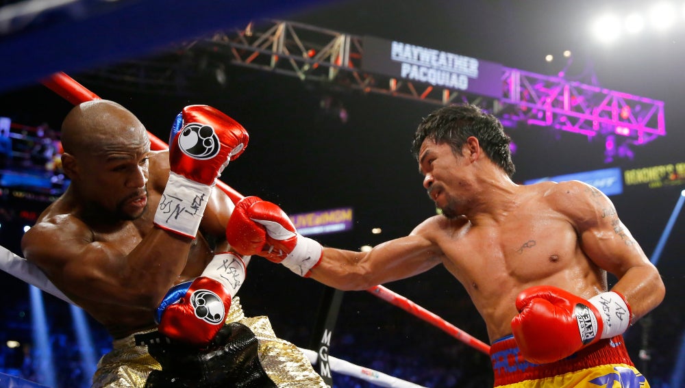 Manny Pacquiao (d) lanza un puñetazo a Floyd Mayweather (izq)