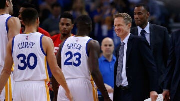 Curry y Green se dirigen al banquillo ante la mirada de Steve Kerr