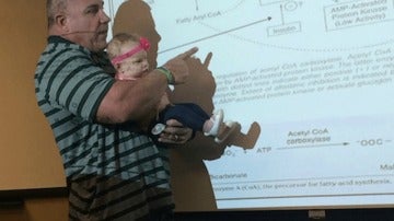 El profesor sosteniendo a la bebé