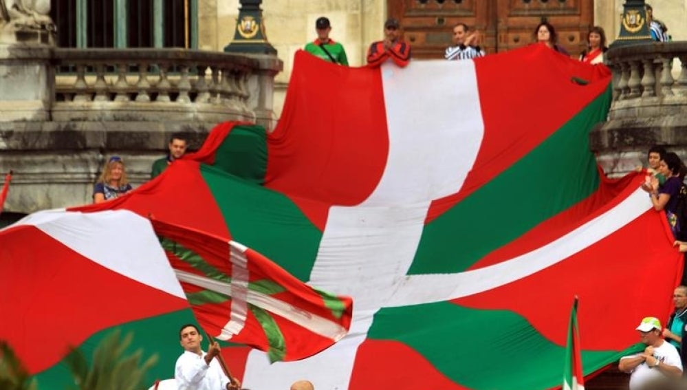 Un grupo de personas sostienen la Ikurriña