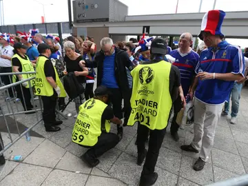 Agentes de seguridad chequean a los asistentes al partido inaugural de la Eurocopa Agentes de seguridad chequean a los asistentes al partido inaugural de la Eurocopa