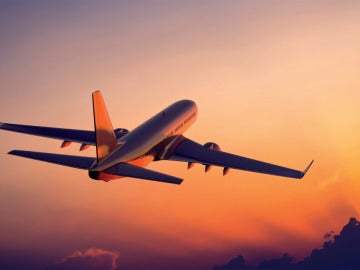 Avión en pleno vuelo al atardecer