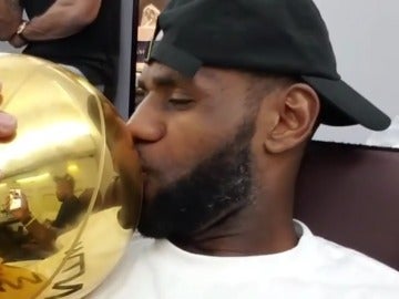 LeBron James besa el trofeo de campeón de la NBA