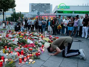 Un joven se lamenta del tiroteo en el lugar del homenaje Un joven se lamenta del tiroteo en el lugar del homenaje