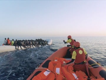 Miembros de ProActiva intentan ayudar a una lancha llena de refugiados