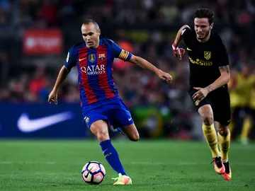 Iniesta conduce un balón ante la presión de Saúl Iniesta conduce un balón ante la presión de Saúl