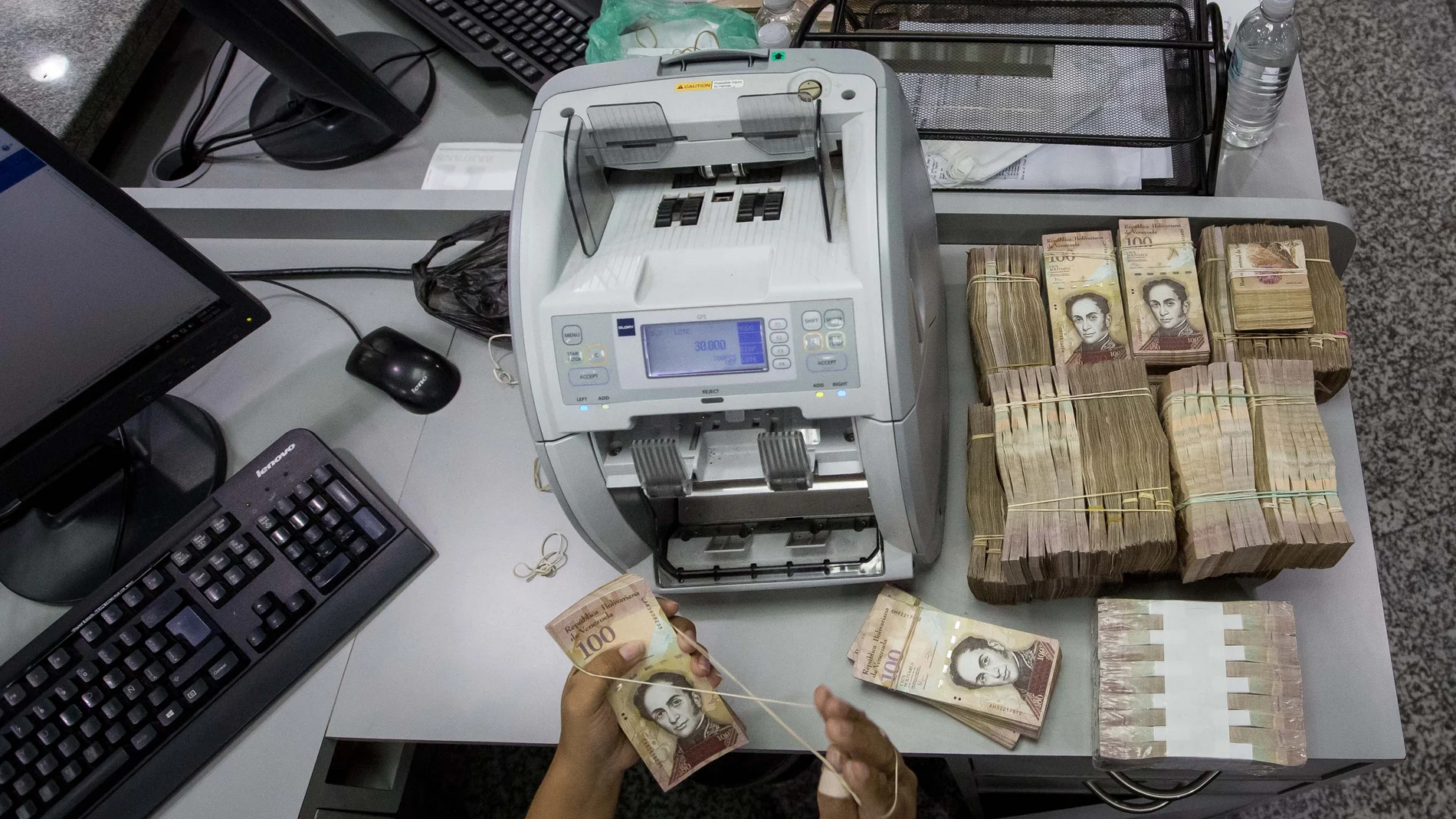 Trabajadoras de un banco cuentan billetes de 100 Bolívares en Caracas (Venezuela) Trabajadoras de un banco cuentan billetes de 100 Bolívares en Caracas (Venezuela)