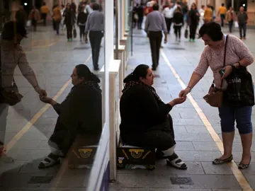 Una mujer pidiendo dinero en las calles de Ronda Una mujer pidiendo dinero en las calles de Ronda