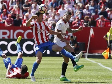 Mikel Vesga y Vitolo disputan el balón en el Sporting - Sevilla