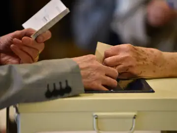 Un votante deposita su voto en una urna a las elecciones presidenciales de Francia Un votante deposita su voto en una urna a las elecciones presidenciales de Francia
