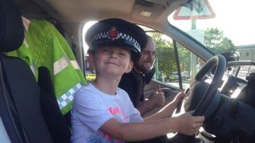 El niño con la gorra de un policía tras llevarles chocolatinas