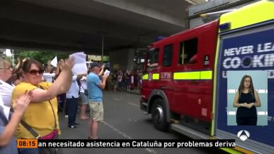 Un grupo de bomberos, recibido entre aplausos a su vuelta de las tareas de búsqueda en la Torre Grenfell