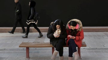 Mujeres chinas mirando su móvil
