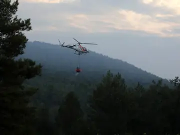 Un helicóptero trabaja en las labores de extinción del incendio forestal declarado en el municipio de Artés (Barcelona) Un helicóptero trabaja en las labores de extinción del incendio forestal declarado en el municipio de Artés (Barcelona)