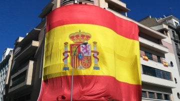 Gran bandera de España colgada en la fachada del Teatro Barceló