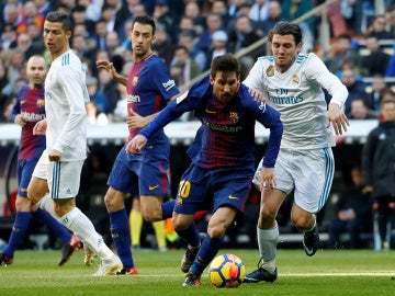 Messi intenta zafarse de la defensa del Real Madrid
