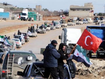 Miembros del Ejército Libre Sirio circulan junto a tropas turcas en la ciudad de Azez, en la zona siria de Afrín