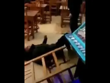 Un agente de la Guardia Urbana junto a un joven en un bar Un agente de la Guardia Urbana junto a un joven en un bar