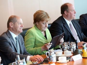La canciller alemana, Angela Merkel (2d); el ministro germano de Finanzas, Olaf Scholz (i), y el ministro alemán de la Cancillería, Helge Braun (d)
