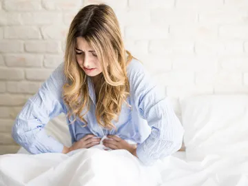 Una chica con la menstruación Una chica con la menstruación