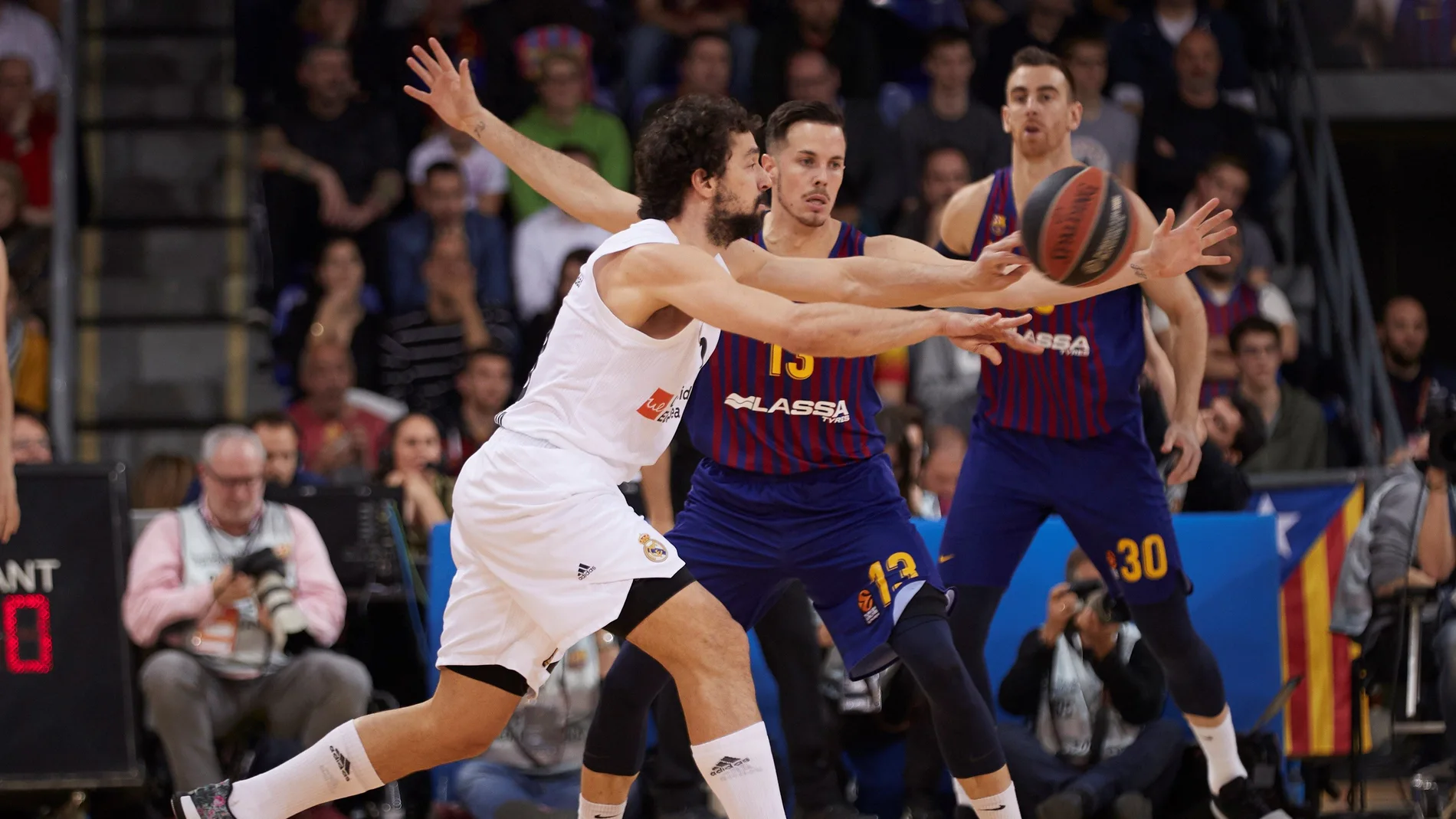 Llull intenta pasar el balón ante la defensa de los jugadores del Barcelona Llull intenta pasar el balón ante la defensa de los jugadores del Barcelona