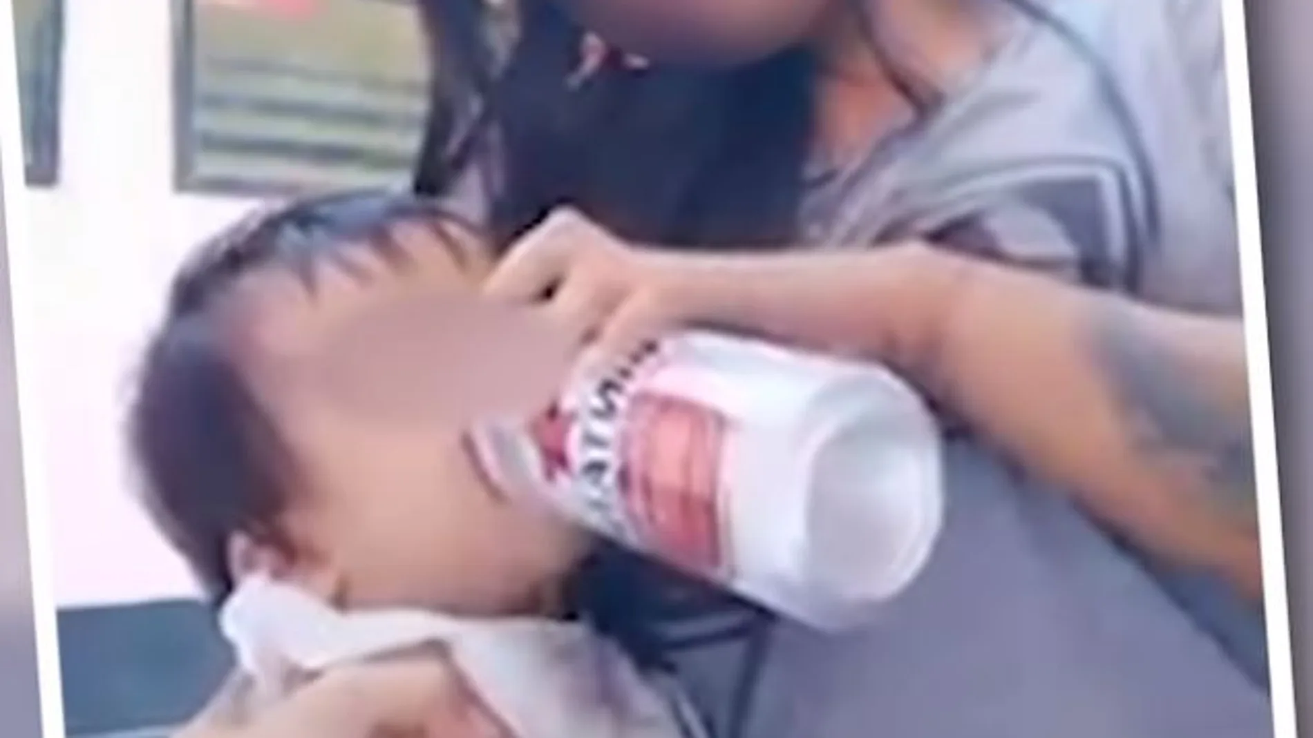 Una madre dándole cerveza a su hijo Una madre dándole cerveza a su hijo