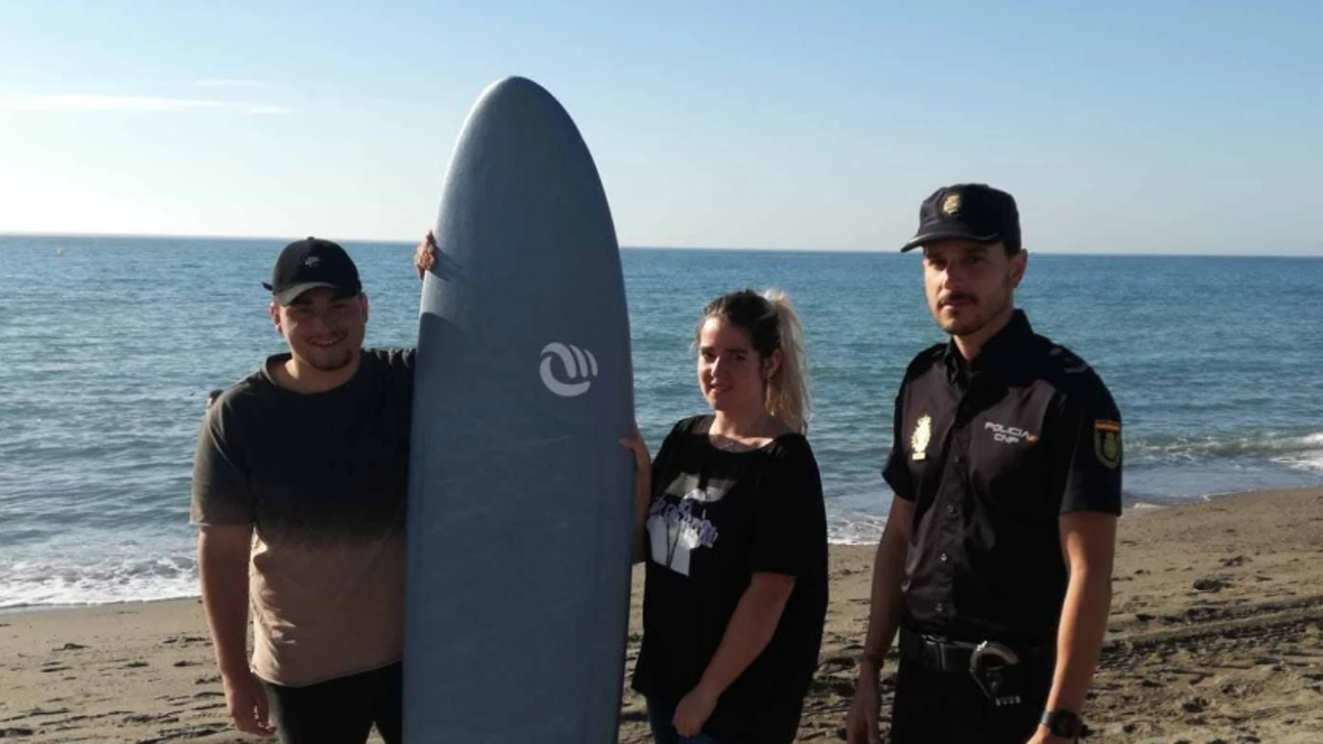 El agente posa con la pareja a la que salvó en una playa de Málaga El agente posa con la pareja a la que salvó en una playa de Málaga