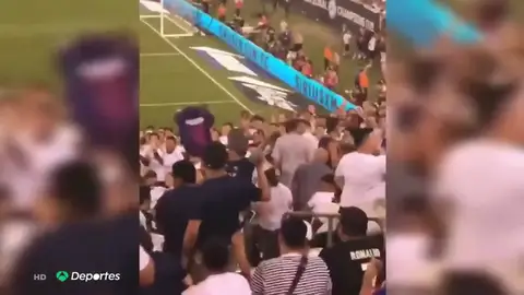 Un hincha huye ante el lanzamiento de objetos por mostrar una camiseta del Barcelona Un hincha huye ante el lanzamiento de objetos por mostrar una camiseta del Barcelona