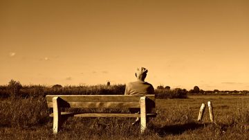 Imagen de archivo de un anciano sentado en un banco