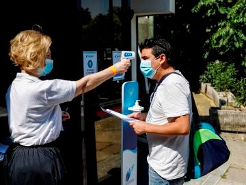 Toma de temperatura a un ciudadano italiano en la entrada a una piscina
