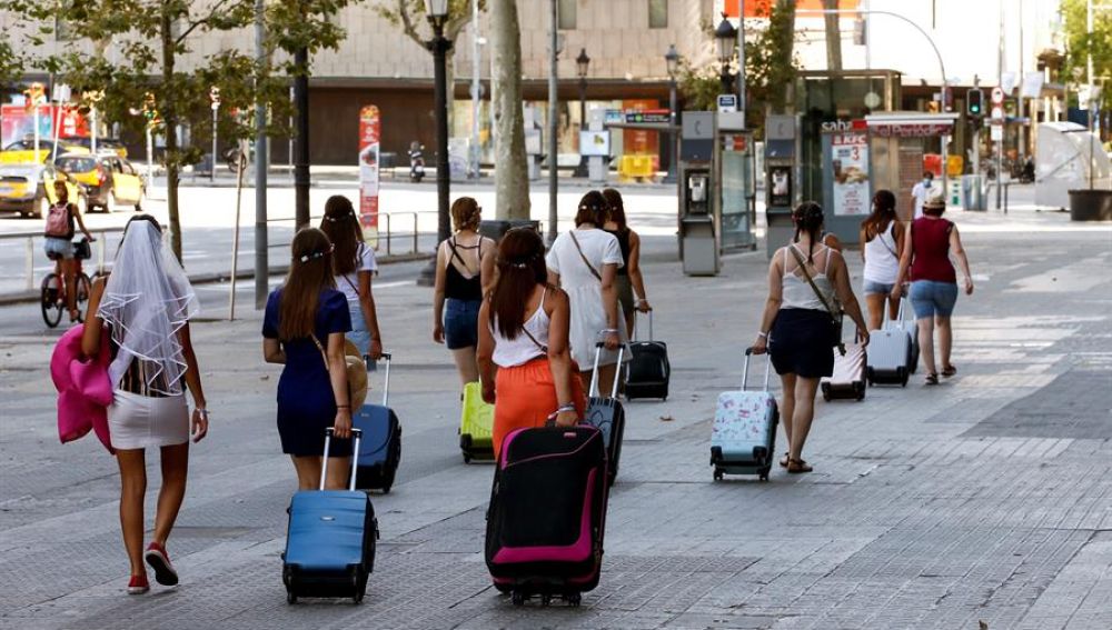 Varias turistas caminando por la Plaza Cataluña de Barcelona