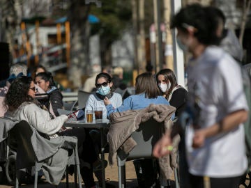 Cuatro personas en la terraza de un bar en Sevilla