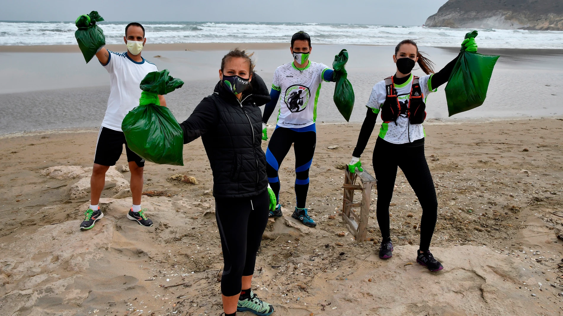 Miembros del grupo "Plogging RRevolution" recogiendo basura en una playa Miembros del grupo "Plogging RRevolution" recogiendo basura en una playa
