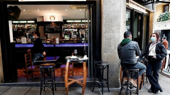  Dos personas toman un aperitivo en el exterior de un bar de Pamplona