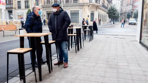 Clientes en la terraza de un bar . Dos personas en la terraza de un bar.