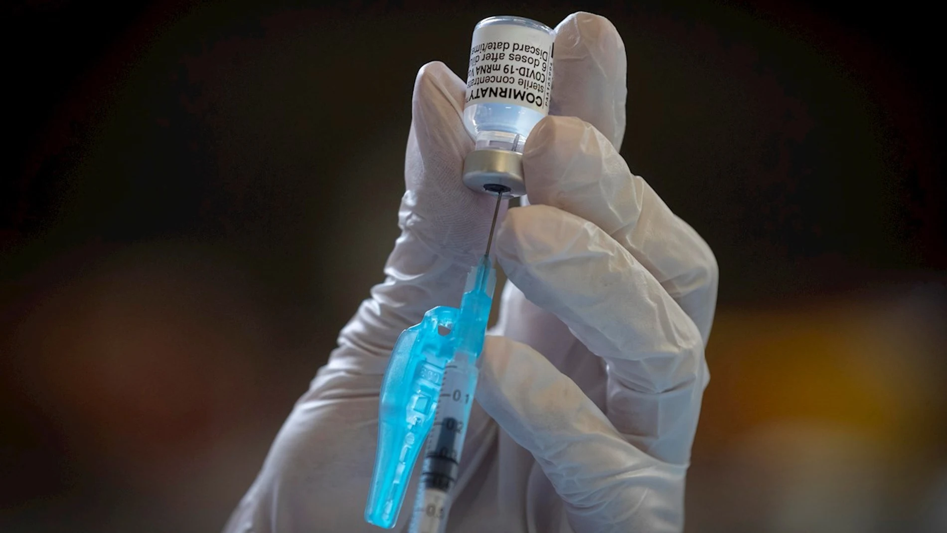 Una enfermera extrae una dosis de un vial de la vacuna contra la covid-19 de la farmacéutica Comirnaty-Pfizer-BioNTech