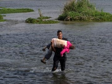 La impactante imagen de una anciana venezolana cruzando el Río Bravo hacia EE.UU. en brazos de otro migrante