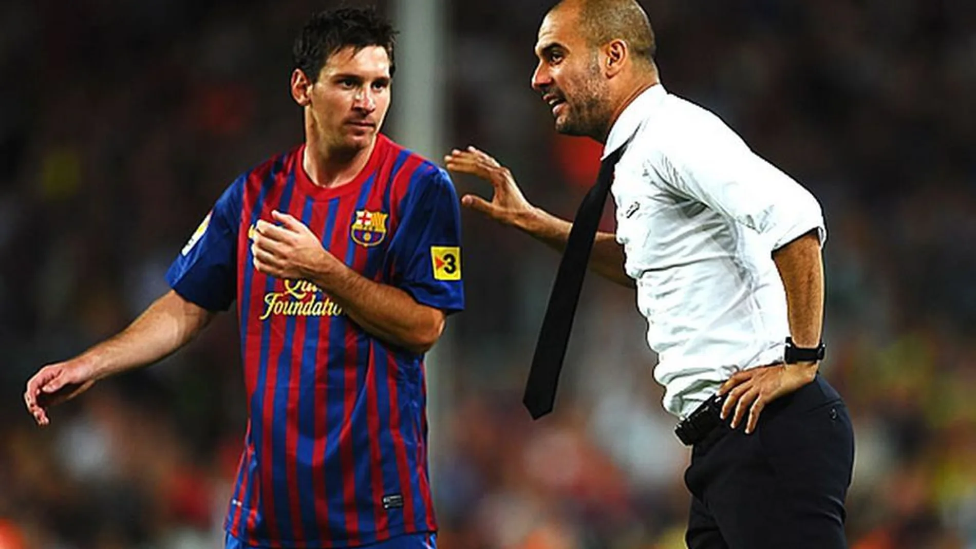 Guardiola, junto a Leo Messi (Archivo)