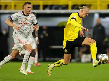 Erling Haaland conduce el balón seguido por Niklas Suele en la final de la Supercopa alemana Erling Haaland conduce el balón seguido por Niklas Suele en la final de la Supercopa alemana