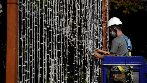 Un operario coloca una cortina de luces led en el Parque de San Francisco en Oviedo, para las próximas fiestas de la ciudad Un operario coloca una cortina de luces led en el Parque de San Francisco en Oviedo, para las próximas fiestas de la ciudad